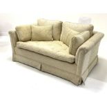 Two seat sofa upholstered in beige fabric, loose cushions, raised on castors, W147cm