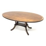 20th century mahogany coffee table, oval cross banded top, four pillar on platform with reeded out s