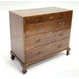 Early 19th century mahogany chest, figured frieze with inlay, three long drawers, raised on ogee bra