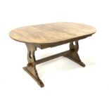 20th century oak dining table, with additional concealed leaf, raised on panel end supports and sled