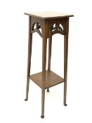 Arts and Crafts style oak jardini�re stand, with pierced frieze, raised on square tapered supports u