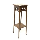 Arts and Crafts style oak jardini�re stand, with pierced frieze, raised on square tapered supports u