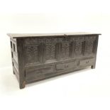 Large 18th century oak mule chest, with hinged lid over four panelled front carved with floral decor