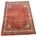 Large Persian Araak carpet, red ground field decorated all over with Boteh motifs, multiple band bor