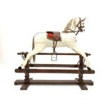 Early 20th century white painted rocking horse, on pine treadle base, L132cm