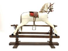 Early 20th century white painted rocking horse, on pine treadle base, L132cm