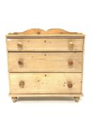 Victorian stripped pine chest, with raised back, fitted with three long graduated drawers, raised on