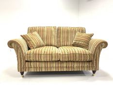 Parker Knoll Burghley two seat sofa upholstered in Baslow Stripe Gold fabric, raised on turned front