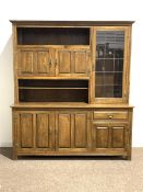 20th century oak dresser, top section fitted with cupboards and open shelves, three panelled cupboar