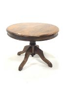 20th century mahogany pedestal lamp table, circular top raised on four reeded supports, D74cm