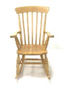 Beech Windsor style farmhouse rocking chair, with broad arms, dished seat, ring turned supports and