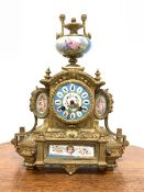 19th century French brass mantel clock with Sevres porcelain panels, surmounted by urn finial, eight