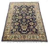 Persian design blue carpet, interlaced trailing foliate of blues, greens, oranges ivory and reds on