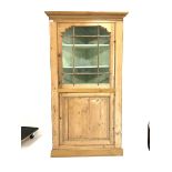 19th century pine standing corner cupboard with glazed upper section and cupboard under on a plinth