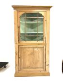 19th century pine standing corner cupboard with glazed upper section and cupboard under on a plinth