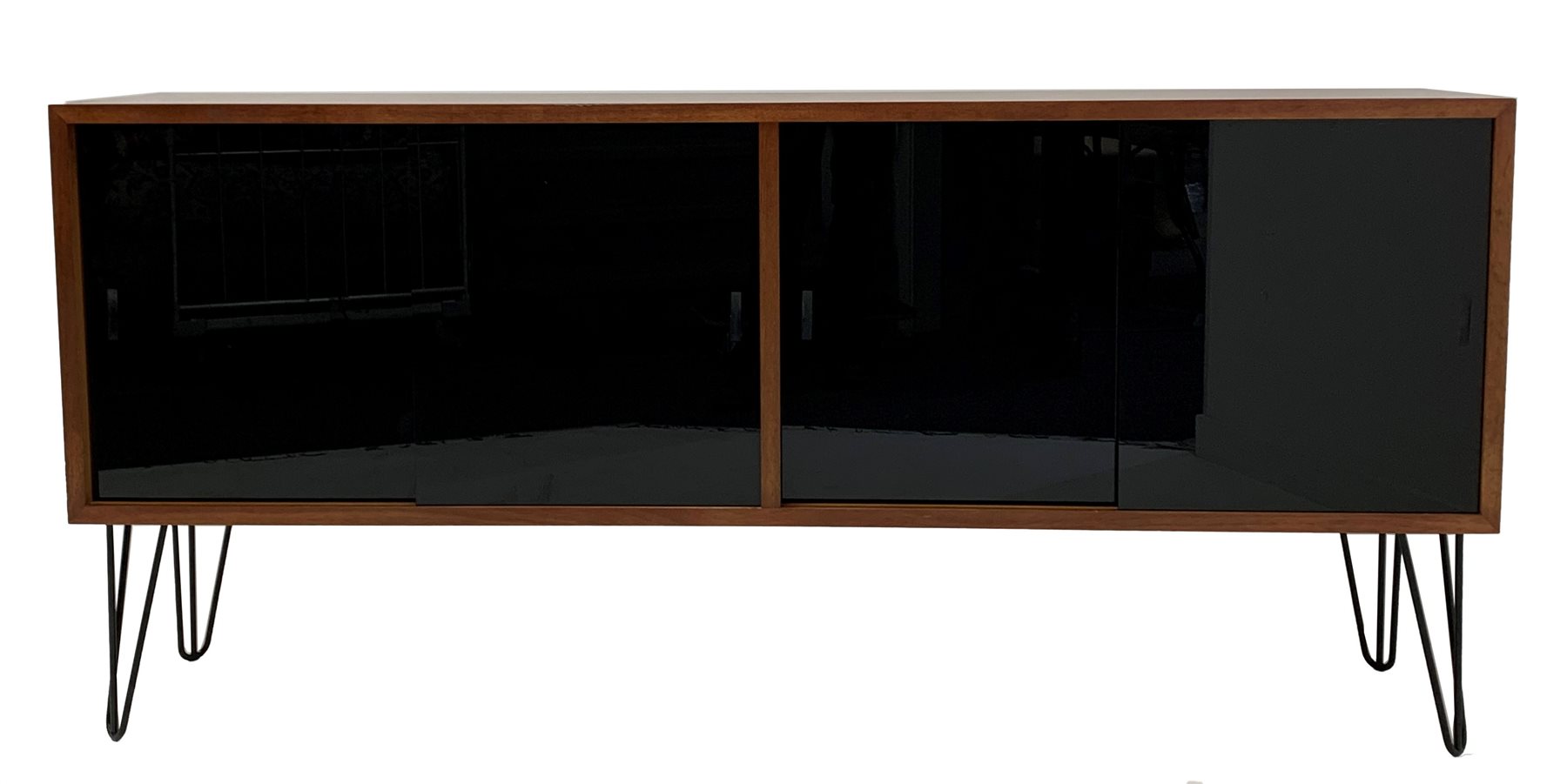 Mid century teak sideboard, fitted with four black lacquered glazed sliding doors enclosing adjustab