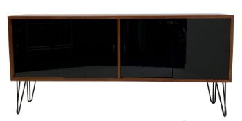 Mid century teak sideboard, fitted with four black lacquered glazed sliding doors enclosing adjustab