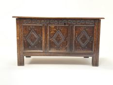 18th Century style oak coffer with moulded top lifting to revel plain interior, 3 panelled front car