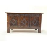 18th Century style oak coffer with moulded top lifting to revel plain interior, 3 panelled front car