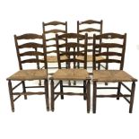 Set of five (2+3) oak ladderback dining chairs, with rush seats, raised on turned supports and stret