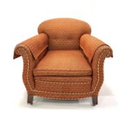 Edwardian easy armchair, upholstered in red and gold fabric with squab cushion, raised on square sup