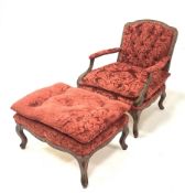 French style figured walnut open armchair, with swept arms and serpentine terminals, upholstered in