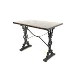 Victorian design cast iron pub table, with stained pine top and supports decorated with scrolled fol