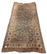 Central Asian design ground carpet, with repeating geometric decoration on blue field, enclosed by m