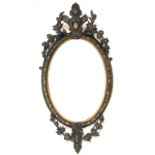 Late 19th century giltwood and gesso oval wall mirror, with bevelled plate enclosed by floral moulde