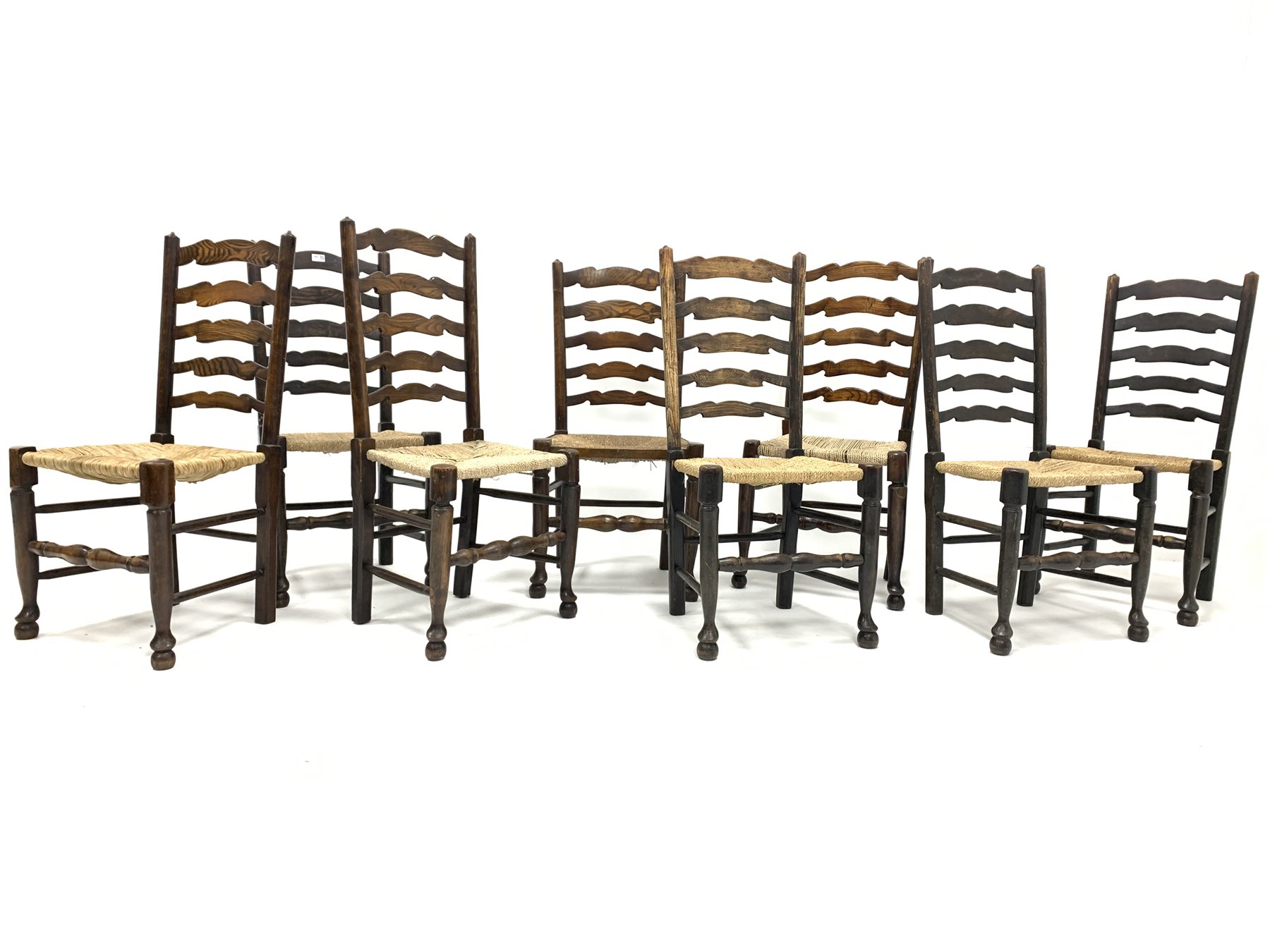 Harlequin set of eight 19th century oak ladder back chairs, with rush seats and turned supports, W49