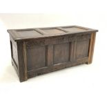 18th century three panel oak coffer carved with scrolls and raised on stile supports, W123cm, H56cm,