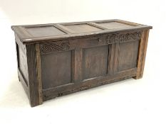 18th century three panel oak coffer carved with scrolls and raised on stile supports, W123cm, H56cm,