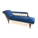 Late Victorian walnut framed chaise longue, with blue velvet upholstery, raised on turned supports a