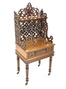 Victorian oak etagere, open shelf raised on scrolled and floral fretwork, over single drawer with bl