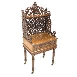 Victorian oak etagere, open shelf raised on scrolled and floral fretwork, over single drawer with bl