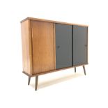 Mid 20th century teak and oak sideboard or bookcase, fitted with three sliding doors enclosing adjus