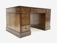 Edwardian mahogany pedestal partners desk with inset writing surface, fitted with nine drawers on a