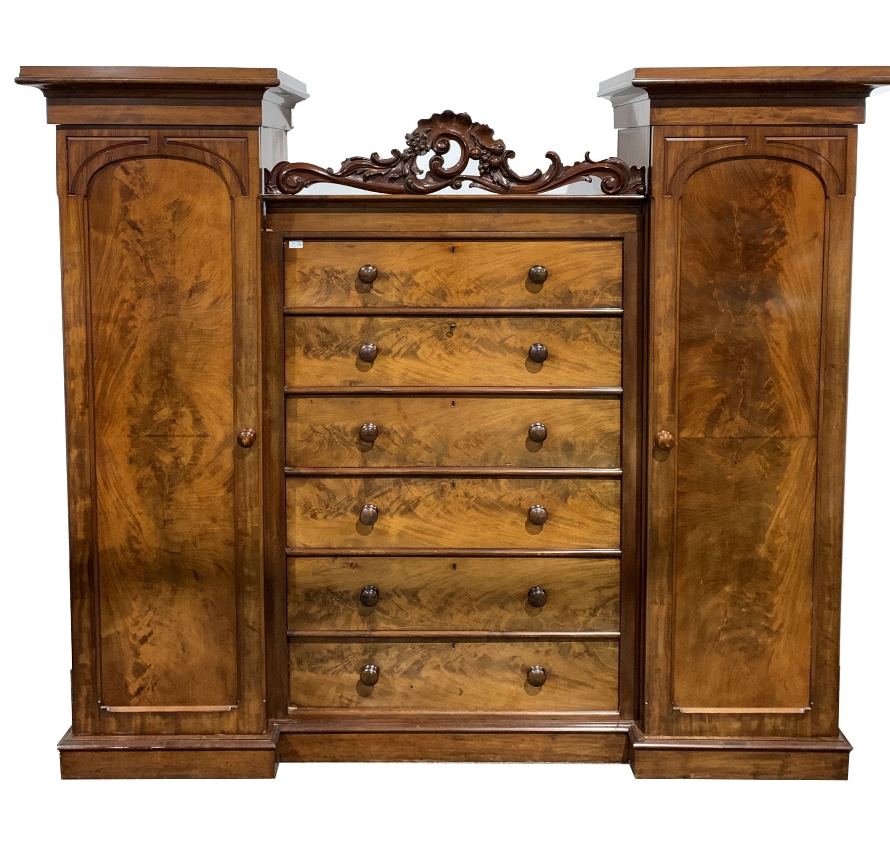 Victorian mahogany combination wardrobe, with a central bank of six drawers flanked by two full leng