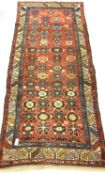 Caucasian runner rug, with stylised floral design on red field, enclosed by guarded border, 270cm x