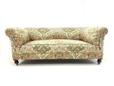 20th century drop arm chesterfield two seat sofa, upholstered in floral linen, and raised on front