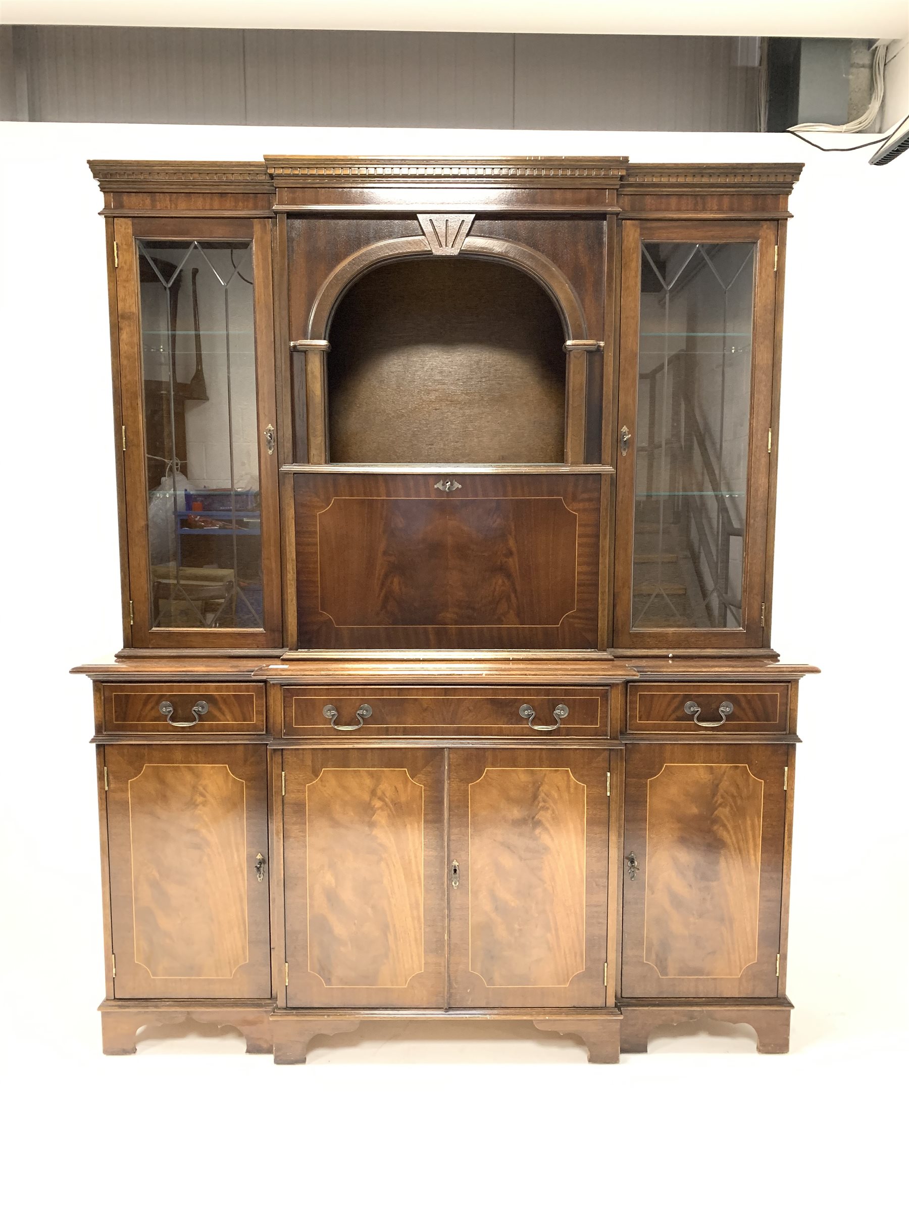 Reproduction mahogany breakfront illuminated cocktail display cabinet, with dentil cornice over glaz