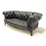 19th century chesterfield two seat drop arm sofa, upholstered in buttoned black leather, raised on m