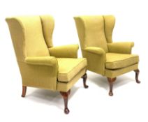 Pair Parker Knoll wingback armchairs, beech framed with cabriole supports, upholstered loose seat cu