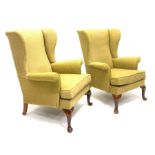 Pair Parker Knoll wingback armchairs, beech framed with cabriole supports, upholstered loose seat cu