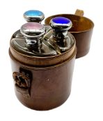 Set of three late Victorian glass spirit flasks with silver and coloured enamel tops