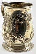 Early George III silver mug with vacant cartouche and embossed decoration with leaf capped handle H1
