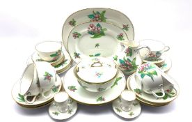 Early 20th century porcelain tea and dinner service, each piece hand-painted with floral sprigs on a