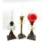 Victorian table oil lamp with glass reservoir on Art Nouveau pierced iron foot H36cm, another on gil