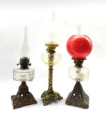Victorian table oil lamp with glass reservoir on Art Nouveau pierced iron foot H36cm, another on gil