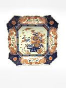 Japanese Meiji period Imari charger of canted square form, painted with a basket of flowers within a